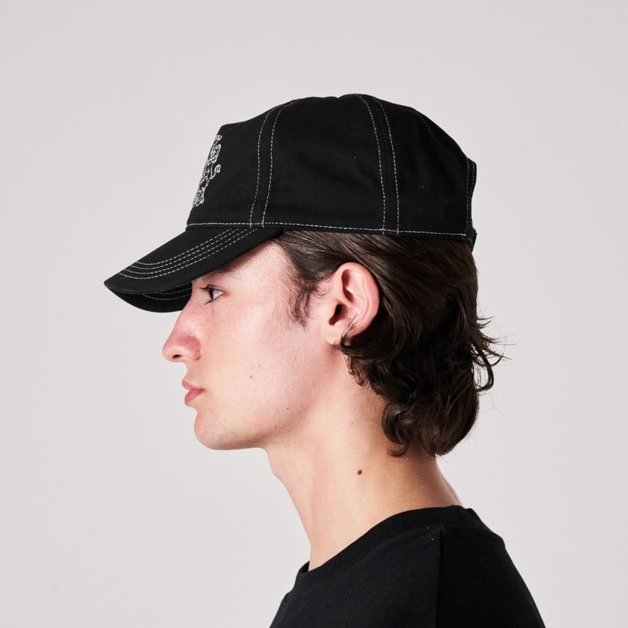 Model wearing the black Gentlemen's Club Cap, side view