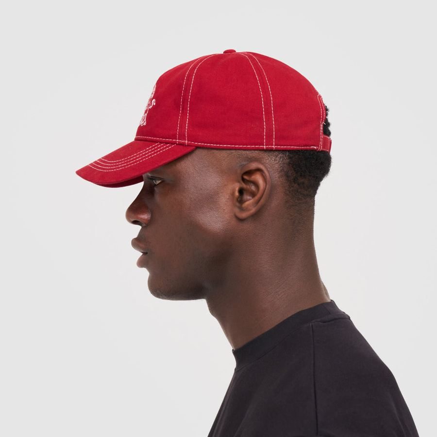 Model wearing the red and white cap, side view